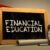 Financial Education Handwritten by white Chalk on a Blackboard.